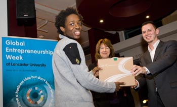 Jameil Robertson winner of the Beermat Challenge Grand Final collecting his prize from Professor Amanda Chetywnd and Enterprise Champion, Jon Powell.