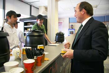 from left:Miguel Binetti and Alistair Reeves serve soup to Ben Wallace MP